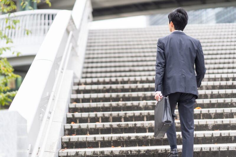 Businessman walking on urban stairs